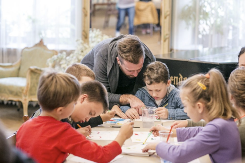 The man conducts art classes for children