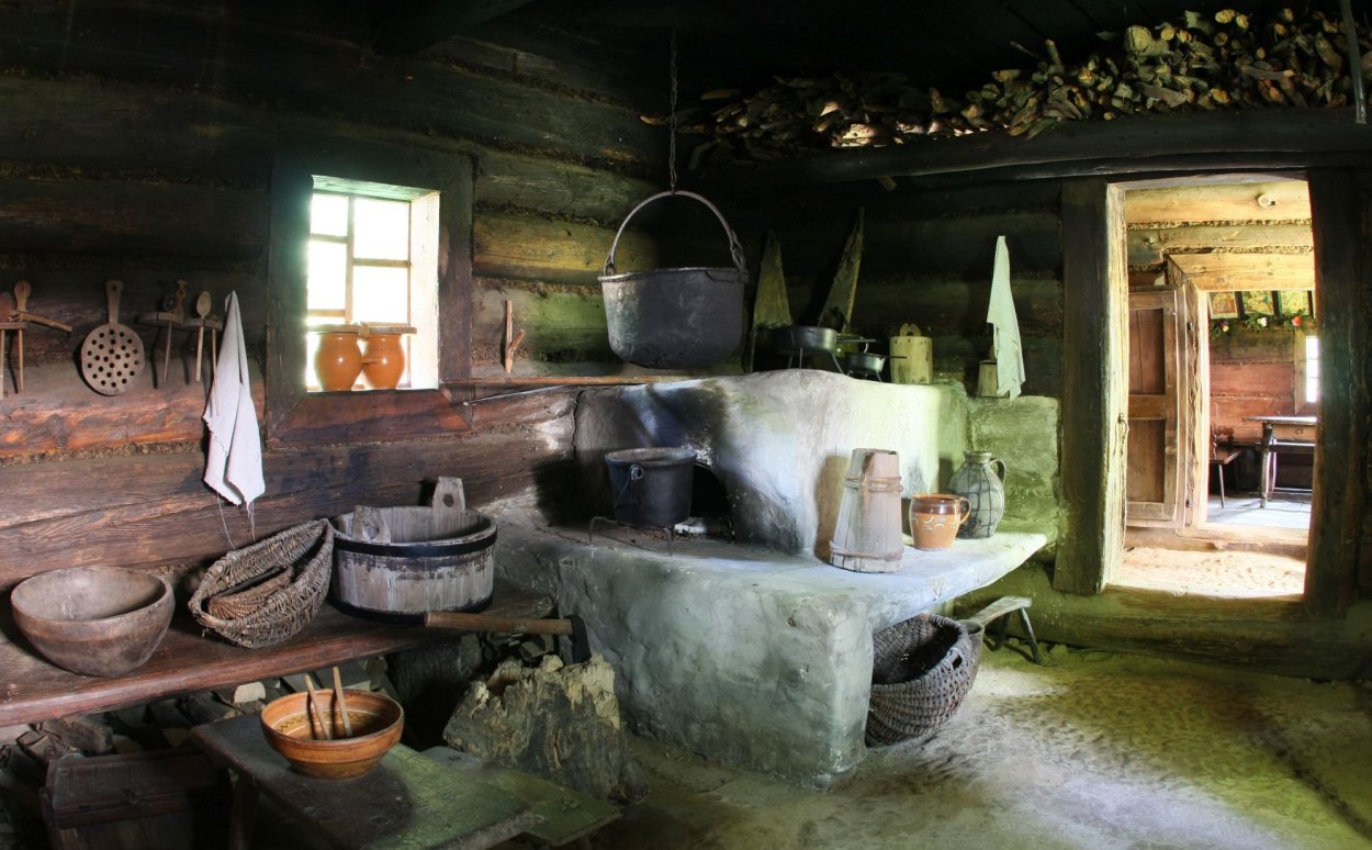 Smoke stove in a room in a wooden cottage