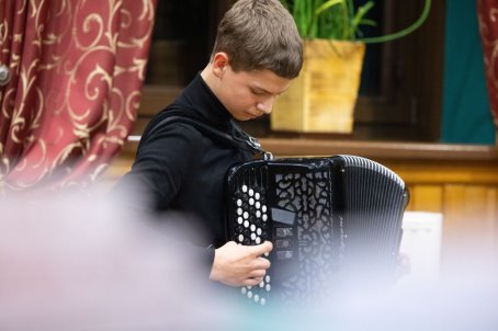 chłopak gra na akordeonie
