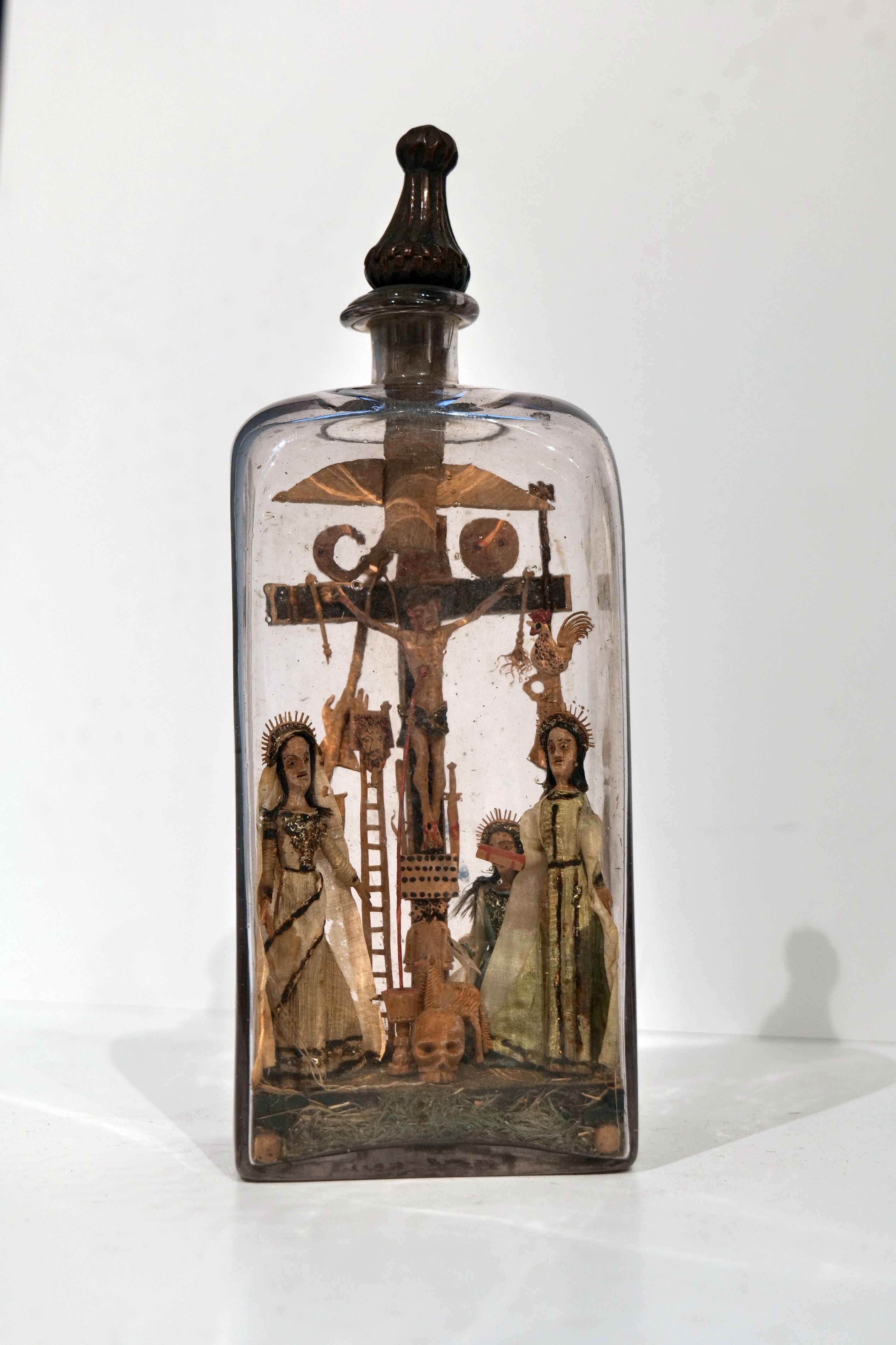 A bottle with the composition of "The Passion of the Lord" inside